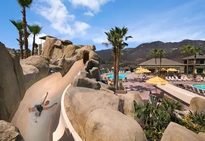 a person riding a water slide at a resort at Hyatt The Welk 2BD in Escondido