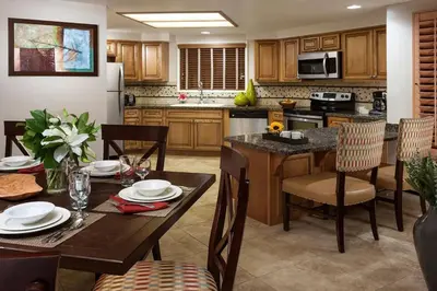a kitchen with a table with chairs and a dining room at Hyatt The Welk 2BD in Escondido