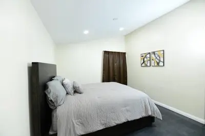a white bedroom with a bed with pillows at Sunny San Diego, Entire home, Pool, Free Parking, BBQ, Pets allowed, family neighborhood! in San Diego