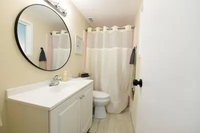a bathroom with a sink and a mirror and a toilet at Sunny San Diego, Entire home, Pool, Free Parking, BBQ, Pets allowed, family neighborhood! in San Diego