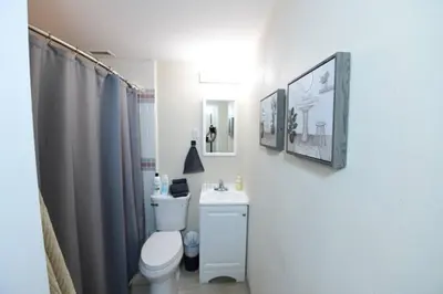 a white bathroom with a toilet and a sink at Sunny San Diego, Entire home, Pool, Free Parking, BBQ, Pets allowed, family neighborhood! in San Diego