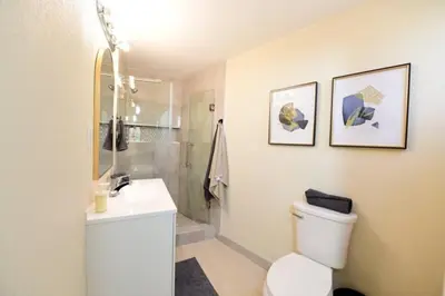 a bathroom with a shower and a toilet and a sink at Sunny San Diego, Entire home, Pool, Free Parking, BBQ, Pets allowed, family neighborhood! in San Diego