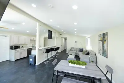 a kitchen and living room with a table and a couch at Sunny San Diego, Entire home, Pool, Free Parking, BBQ, Pets allowed, family neighborhood! in San Diego