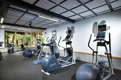 a gym with several tread machines in a room at Oceanside Beach Condos in Oceanside
