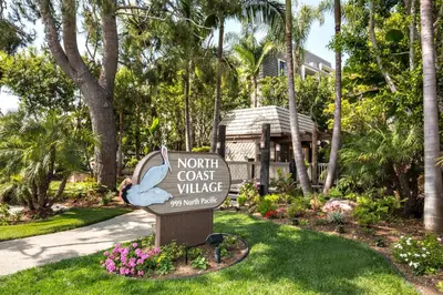 a sign for a north coast villa in a yard at Oceanside Beach Condos in Oceanside