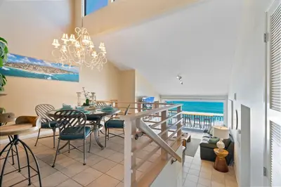 a dining room with a table and chairs and a view of the ocean at Picturesque Perfection in Leucadia in Encinitas