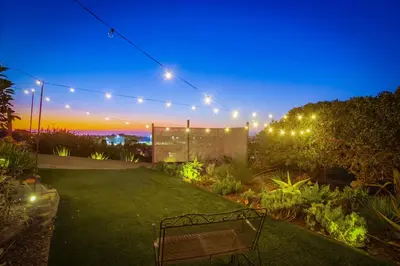 a garden at night with a bench and lights at Red Hawk Coastal Estate in San Diego