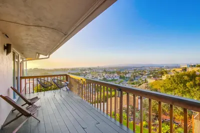 a balcony with benches and a view of a city at Red Hawk Coastal Estate in San Diego