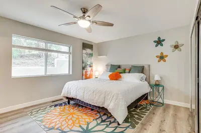 a bedroom with a bed and a ceiling fan at San Marcos Getaway with Deck and Lake Views! in San Marcos