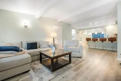 a living room with a couch and a table at Sunlit Shores beachside Bliss in San Diego