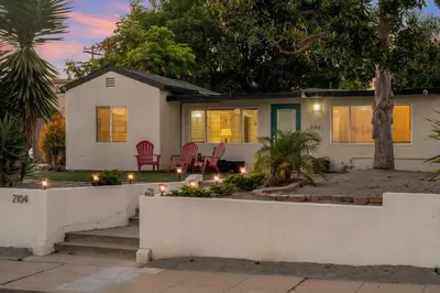 a house with lights in the front yard at Sunlit Shores beachside Bliss in San Diego