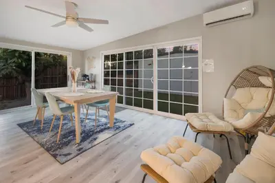 a dining room with a table and chairs at Sunlit Shores beachside Bliss in San Diego