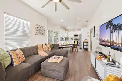 a living room with a couch and a tv at Catch n' Relax on Nimitz- Minutes from the Harbor in San Diego