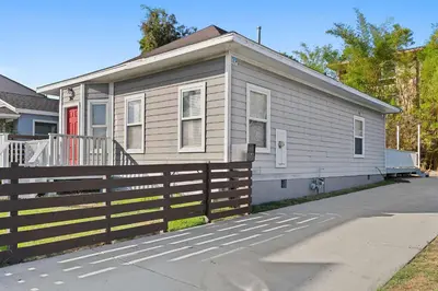 a house with a wooden fence in front of it at Catch n' Relax on Nimitz- Minutes from the Harbor in San Diego