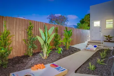 a backyard with a wooden fence and a table at Ultimate Getaway: Spa Game Rooms Firepit Views in San Diego