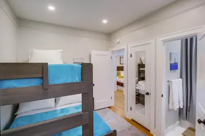 a bedroom with a bunk bed with blue sheets at Ultimate Getaway: Spa Game Rooms Firepit Views in San Diego