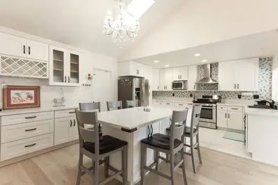 a kitchen with white cabinets and a table and chairs at Pristine Poway Retreat in Poway