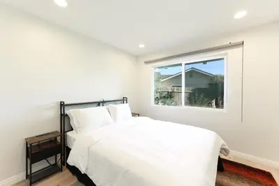 a white bedroom with a bed and a window at Pristine Poway Retreat in Poway