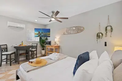 a living room with a white couch and a table at Endless Summer Beach Studio - Beach - AC - Shops in San Diego