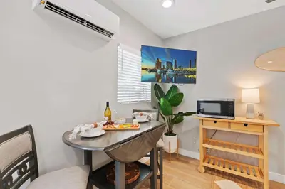 a dining room with a table and a tv at Endless Summer Beach Studio - Beach - AC - Shops in San Diego