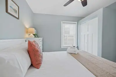 a bedroom with a bed with a teddy bear sitting on it at Endless Summer Cottage - Patio - AC - Beach in San Diego