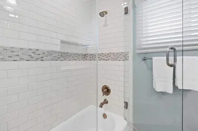 a bathroom with a shower with a glass door at Endless Summer Cottage - Patio - AC - Beach in San Diego