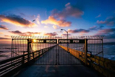 a beach fishing pier with the sunset in the background at Endless Summer Cottage - Patio - AC - Beach in San Diego