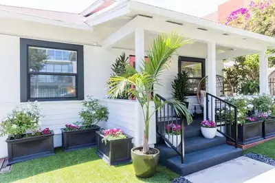 a house with potted plants on the front porch at Little Italy 3BD Home with Huge Patio & Backyard in San Diego