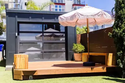 an umbrella sitting on a table in the grass at Little Italy 3BD Home with Huge Patio & Backyard in San Diego