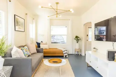 a living room with a couch and a table at Little Italy 3BD Home with Huge Patio & Backyard in San Diego