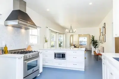 a kitchen with white cabinets and a stove at Little Italy 3BD Home with Huge Patio & Backyard in San Diego