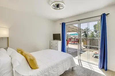 a bedroom with a bed and a sliding glass door at Poway Retreat with Stunning Sunset and Mountain Views! in Poway