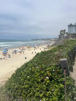 a beach with a bunch of people and the ocean at Ocean Breeze 2 bedroom in San Diego