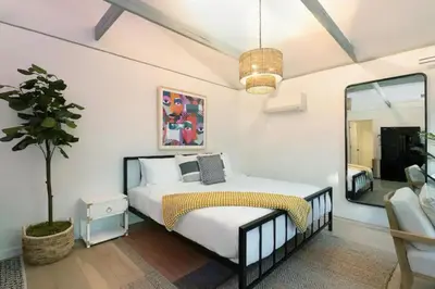 a bedroom with a bed and a large mirror at Quaint Studio for 2 in the Heart of Little Italy in San Diego