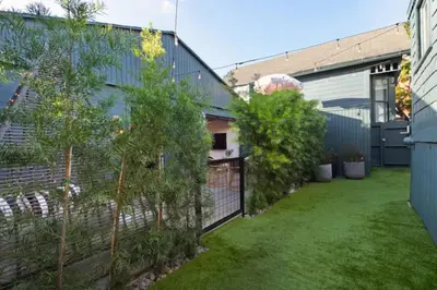 a backyard with a fence and some trees at Quaint Studio for 2 in the Heart of Little Italy in San Diego