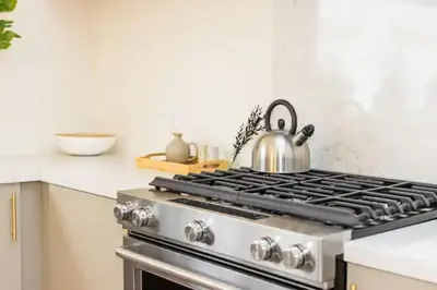 a tea kettle sitting on top of a stove in a kitchen at Bright, Spacious 4 BD in the Heart of Little Italy in San Diego