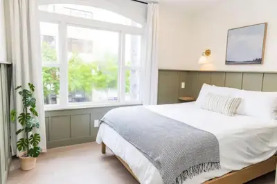 a bedroom with a large bed and a window at Bright, Spacious 4 BD in the Heart of Little Italy in San Diego