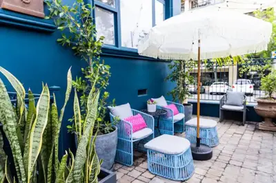 a patio with chairs and an umbrella and plants at Cheerful 4BD Home in the Heart in San Diego
