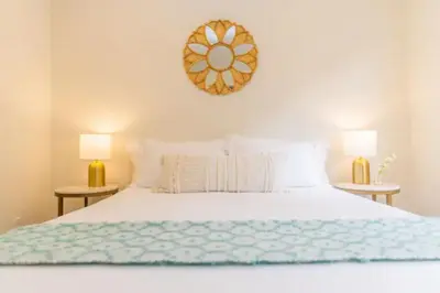 a bedroom with a white bed with two lamps at Cheerful 4BD Home in the Heart in San Diego