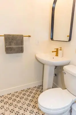 a bathroom with a white toilet and a sink at Cheerful 4BD Home in the Heart in San Diego
