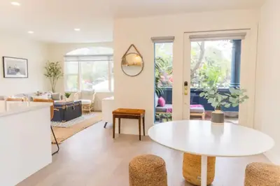 a living room with a white table and chairs at Cheerful 4BD Home in the Heart in San Diego