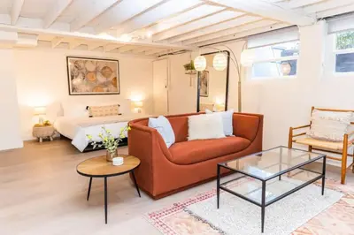a living room with a couch and a bed at Lovely Studio in the Heart of Little Italy in San Diego