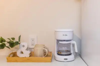 a coffee maker on a counter with a wooden tray at Lovely Studio in the Heart of Little Italy in San Diego