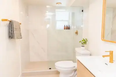a bathroom with a shower and a toilet and a sink at Lovely Studio in the Heart of Little Italy in San Diego