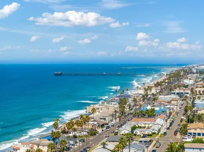 an aerial view of a beach with a pier at Sunsets at the Beach House in Oceanside