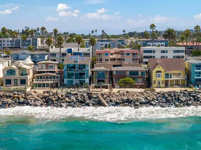 a group of houses on the beach near the water at Sunsets at the Beach House in Oceanside