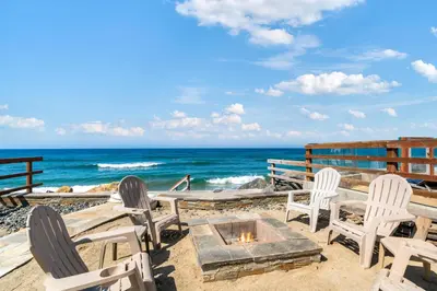 a group of chairs and a fire pit on the beach at Sunsets at the Beach House in Oceanside