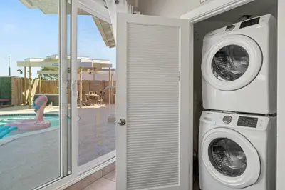 a washer and dryer in a room with a pool at The Sky Lounge in La Mesa