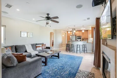 a living room with a couch and a table at Steps to the boardwalk & beach with AC, WiFi, spacious deck, prime location in San Diego