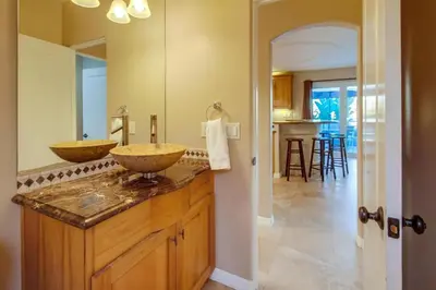 a bathroom with two sinks on a wooden counter at Steps to the boardwalk & beach with AC, WiFi, spacious deck, prime location in San Diego